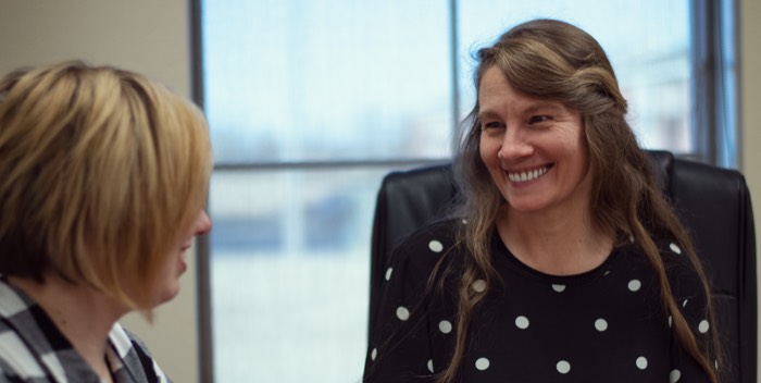 Sherry Taylor smiling with a client during a coaching session.
